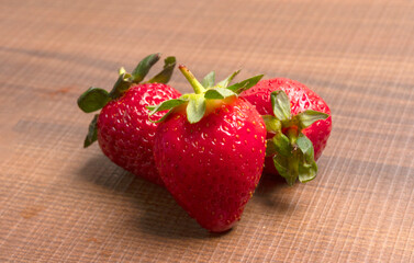 Fresh and Juicy beautiful organic strawberries on wooden background. Top view point.