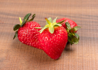 Fresh and Juicy beautiful organic strawberries on wooden background. Top view point.