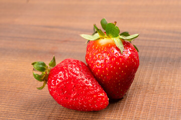 Fresh and Juicy beautiful organic strawberries on wooden background. Top view point.