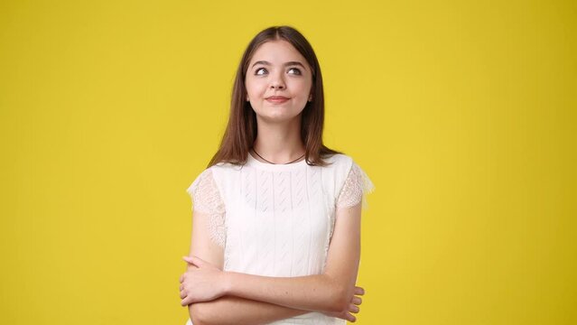 4k video of girl with cunning facial expression on yellow background.