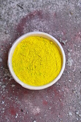 top view of colorful traditional holi powder in bowls isolated on dark background.Space for text . happy holi.Concept Indian color festival called Holi