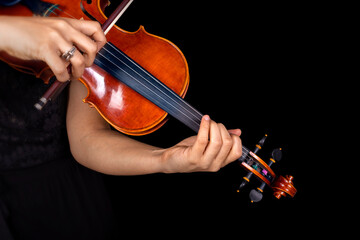 Violinist playing violin on dark background