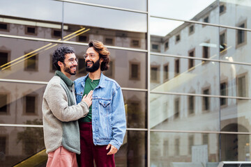 Obraz premium couple of gay men smiling happy and hugging tenderly, concept of freedom and love between people of the same sex, copy space for text