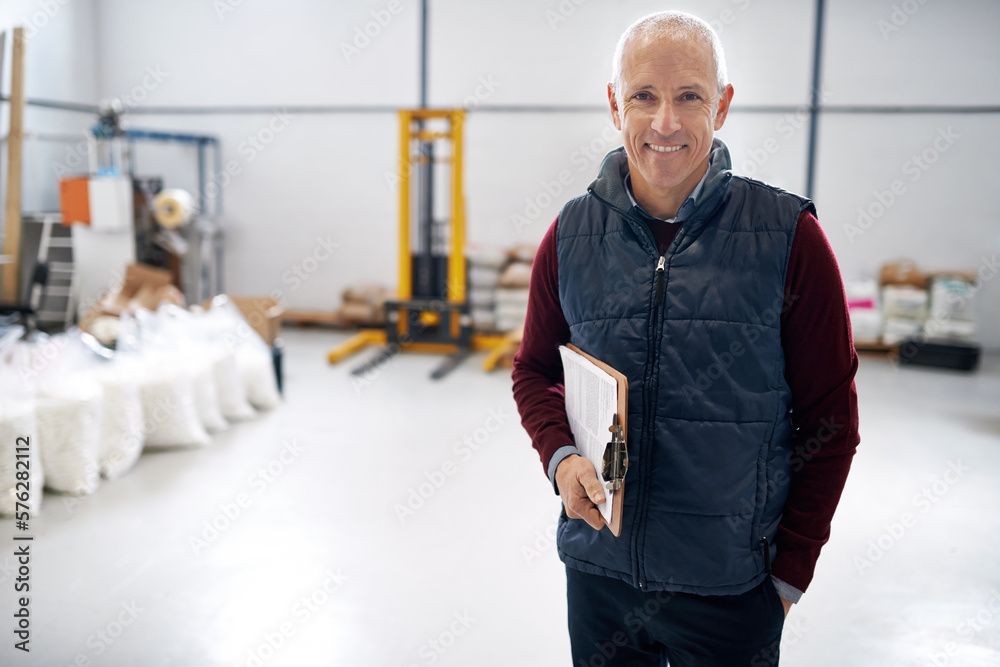 Poster here to do some inspecting. portrait of a male foreman standing on the factory floor with a clipboar