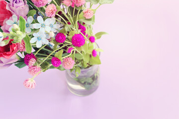 Top view image of pink and purple flowers composition over pastel background