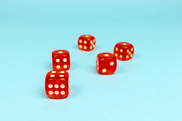 Red dice for boarding games on a blue background.