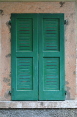 Close Up of Window with Closed Green Wooden Shutters in Old Italian Building  