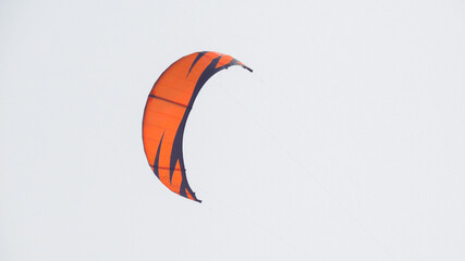 orange sport kite in the sky, parachute