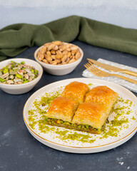 Pistachio baklava on white marble. Traditional middle eastern dessert. Turkish Antep baklava.