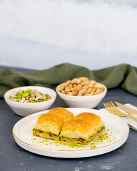 Pistachio baklava on white marble. Traditional middle eastern dessert. Turkish Antep baklava.