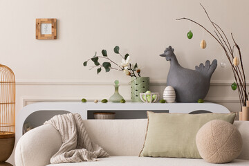 Creative composition of easter living room interior with hen sculpture, easter eggs, easter bunny,...