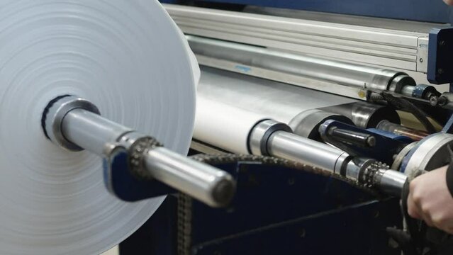 changing the plastic roll on the machine in the factory