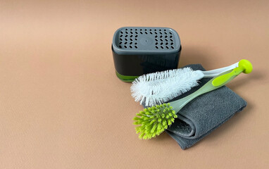 Kitchen dispenser, towel and brushes. Cleaning service, space for text. Detergent dispenser.