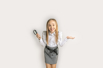 astonishment smiling little girl holds magnifying glass on white background.