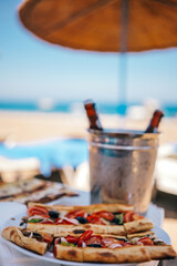 Turkish Pide with vegetables and two bottles of beer in ice bucket at Summer Beach Lounge