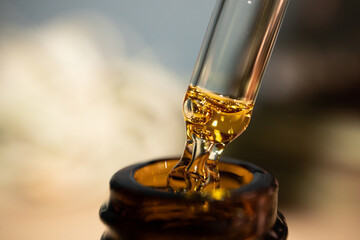 CBD Oil glass pipette. Oil close-up shot. Macro. THC. Cannabis sativa extract. Healthcare. - obrazy, fototapety, plakaty