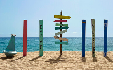 Empty colorful wooden direction sign on the beach, image for vacation concept and inspiration.