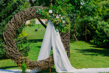 The original wedding decor at the exit registration in the summer. Circle of branches. big frame