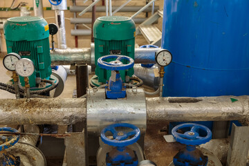 Electric pump with manometer. Pumping station in the basement with two motors