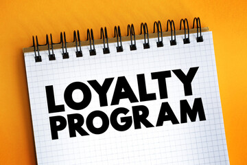Loyalty Program - marketing strategy designed to encourage customers to continue to shop and use the services of a business associated with the program, text on notepad