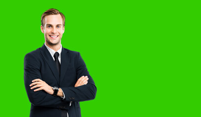 Obraz na płótnie Canvas Portrait of businessman in black suit, with folded arms, green chroma key background. Smiling business man at studio picture. Copy space for text.