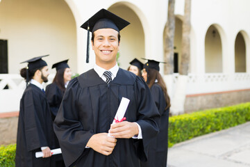 Smiling man graduate finishing university education