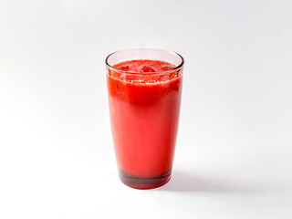 Refreshing lemonade from berries in glass of colored glass on white background