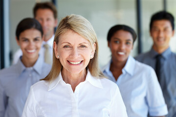 Fototapeta premium Lucky to have this team on my side. Shot of a senior businesswoman with her team in their office.