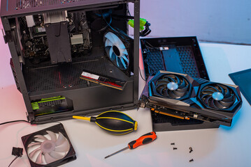 The master repairman with a brush cleans dust from the heatsink of the PC central processor cooling. Home pc maintenance
