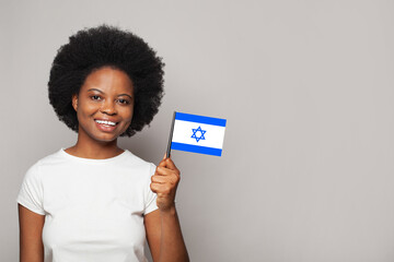 Izraeli woman holding flag of Izrael. Education, business, citizenship and patriotism concept - obrazy, fototapety, plakaty