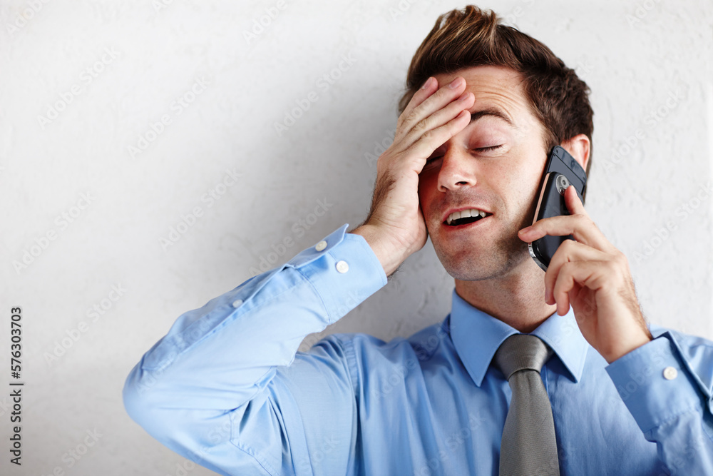 Wall mural utter relief after getting the promotion. a relieved young businessman rubbing his face while taking