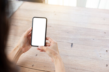 cell phone blank white screen mockup.hand holding texting using mobile on desk at office.background empty space for advertise.work people contact marketing business,technology