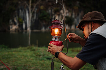 Asian man lanterns are lit Kerosene lamp at the lakeside. Vintage style lantern at night outdoor....