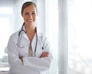 Put your trust in her. Portrait of an attractive young doctor standing with her arms folded.