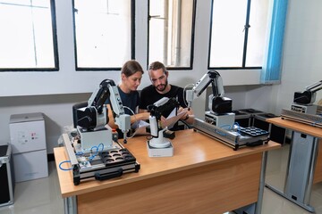 An engineer in research development robotic factory checking prototype of automation robot arm