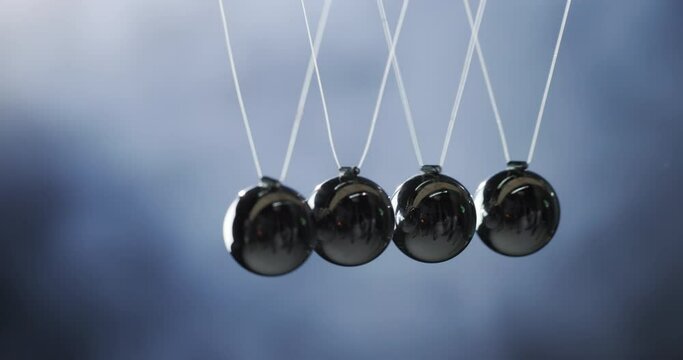 Demonstrates the law of energy conservation, momentum is transmitted from one ball to another