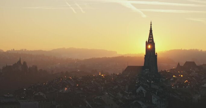 4K day to night time lapse Cityscape historical Old town of Bern, Switzerland. Attractive evening city view on bridges over Aare river and church tower during dramatic sunset timelapse. Swiss, Europe.