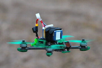 drone in flight in blur. Freestyle FPV unmanned quadcopter with blurry hills. The concept of new technologies and innovations.