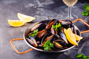 Delicious seafood mussels with sauce and parsley.