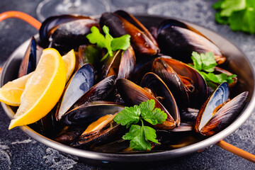 Delicious seafood mussels with sauce and parsley.