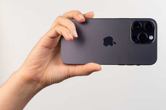 Back view of iphone pro in one hand