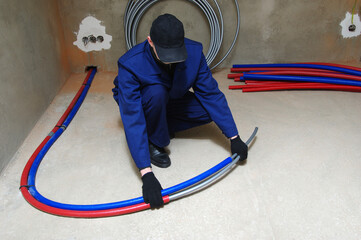 Plumber installing plastic pipes