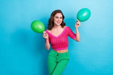 Photo of adorable positive lady wear trendy clothes hold two air ballon prom hen party isolated on blue color background © deagreez