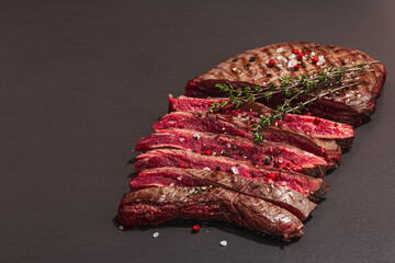 Medium rare Flank steak with spices and herbs. Classic grilled meat cut ready to eat