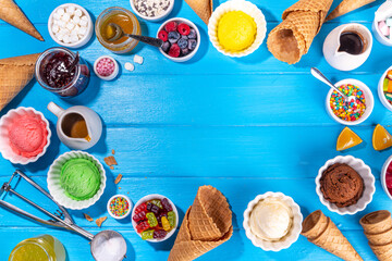 Ice cream festival background, Summer ice cream buffet with various gelato sundaes flavors. sweet toppings and sprinkles, high-colored blue wooden background to view copy space