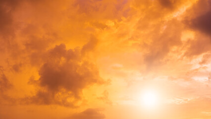 Fototapeta na wymiar Sunset sky with dramatic orange, yellow sunrise clouds in the morning 