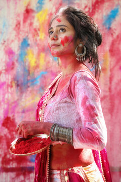 Woman celebrating Holi festival. Festival of colors.