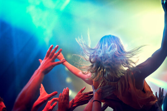 Crowd Surfing. A Young Girl Crowd Surfing As A Band Plays One Of Her Favourite Songs.