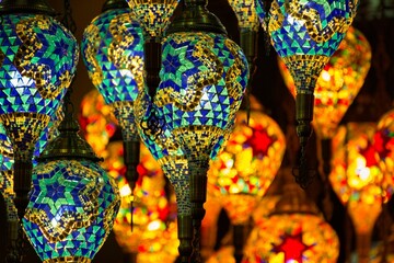 Colourful image of dozens of brightly coloured oriental mosaic lamps.