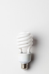 Spiral white light bulb. Energy saving fluorescent light bulb on white background. Green concept. 